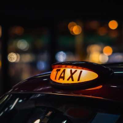 Illuminated orange Taxi sign